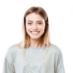 happy-young-woman-standing-isolated-white-wall